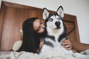 woman loving on dog